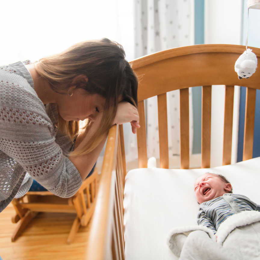 gassy infant crying in their crib