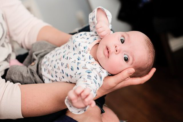 infant being held during CST session
