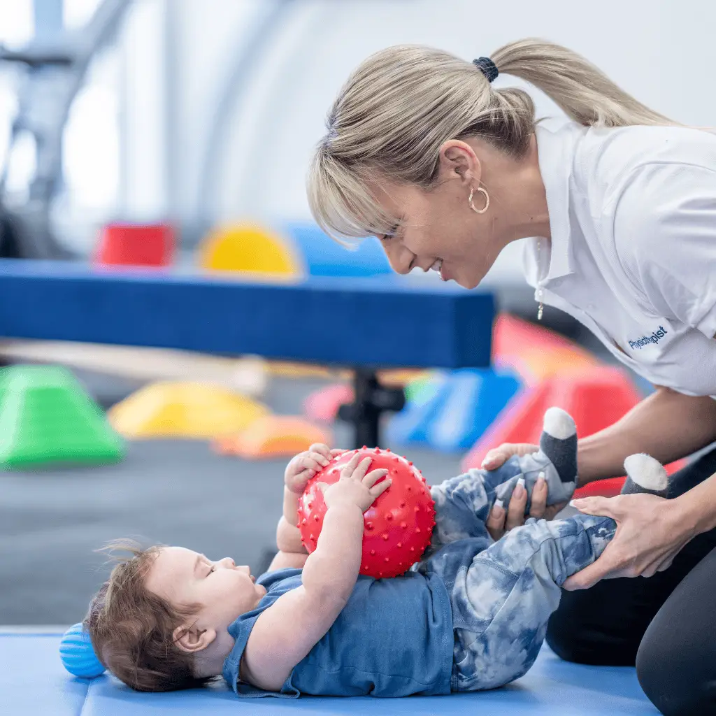 Child receiving craniosacral therapy during occupational therapy session.